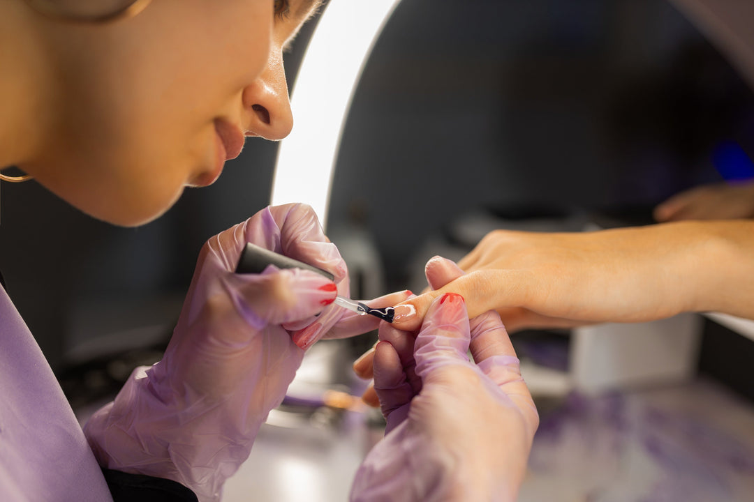 Nail technician capping the free edge with a thin layer of BIAB