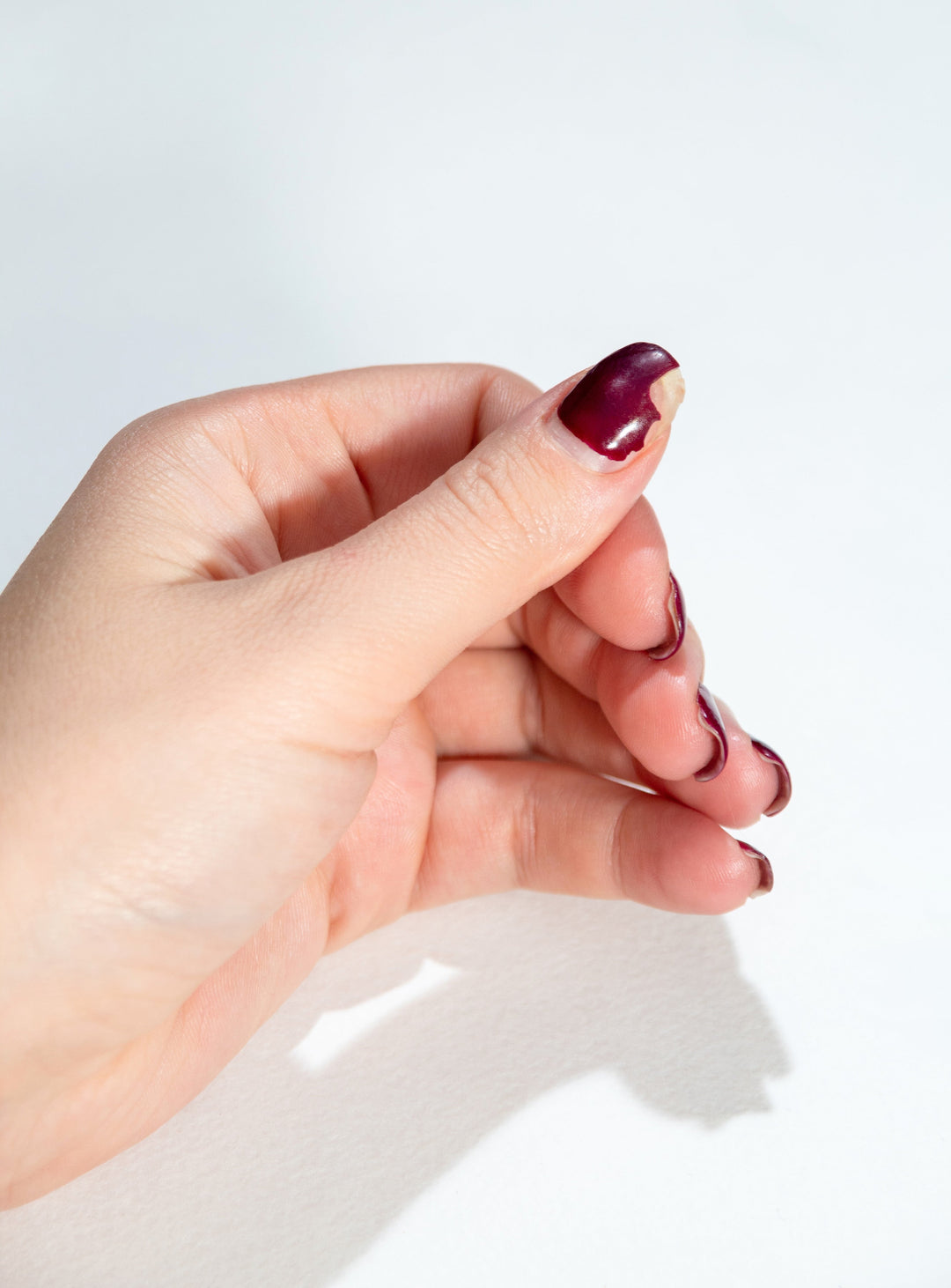 A small chip on the free edge of a BIAB manicure