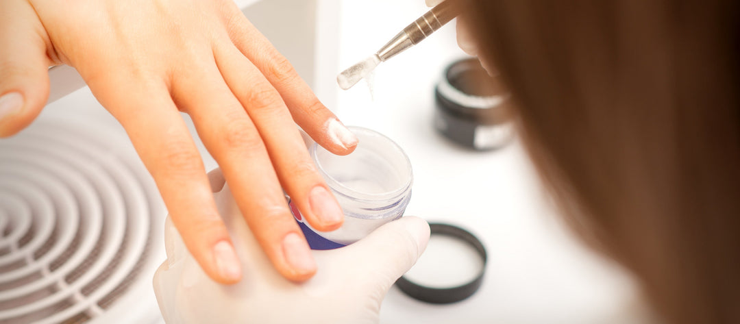 Acrylic powder being applied during a manicure