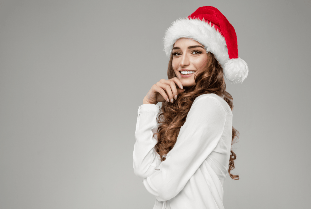 Attractive woman with manicured nails and a santa hat
