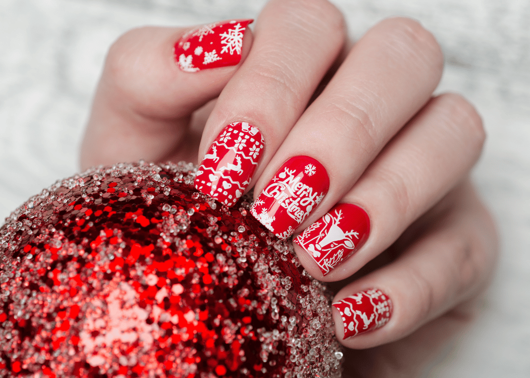 Christmas themed nails holding a Christmas bauble