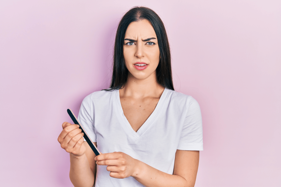 Confused woman with nail file