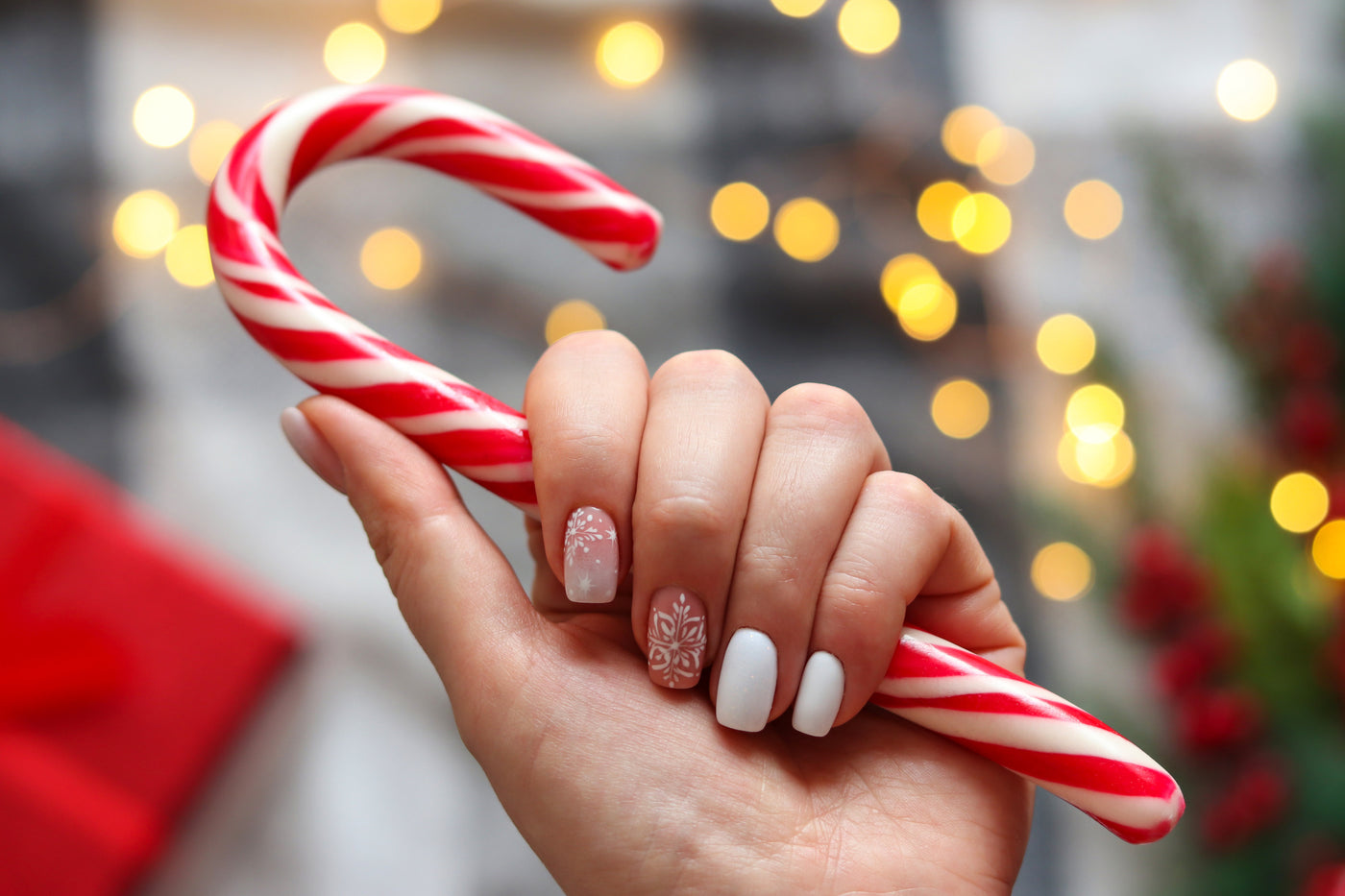 Winter nails holding a candy cane