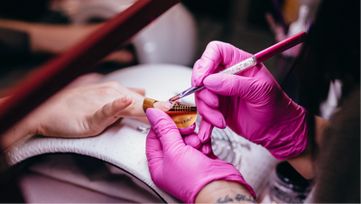 Acrylic being applied to nails