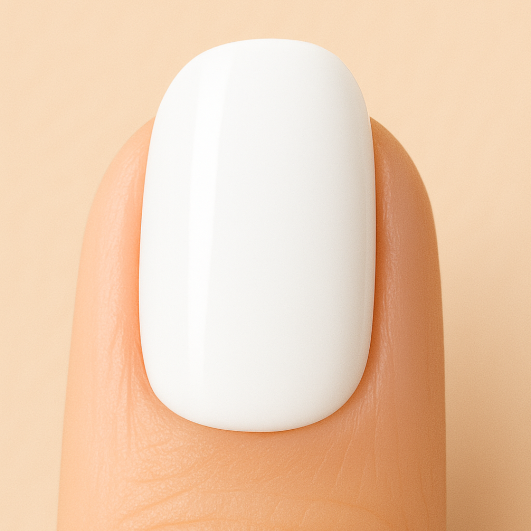 White Gel polish on a nail against a beige background