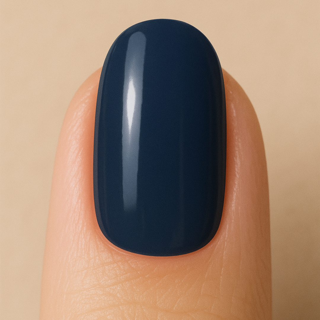 Nail with dark navy gel nail polish on a beige background